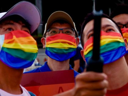 LGBT rights activists take selfies during a gay pride parade outside the Chiang Kai-shek M