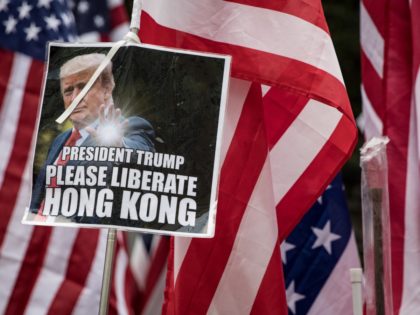 HONG KONG, CHINA - SEPTEMBER 08: Protesters hold American flags as they walk through Centr