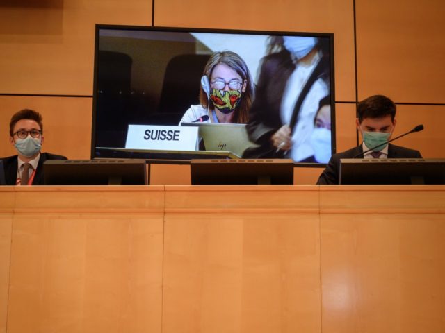 Delegates wearing wearing a protective face mask attend the resuming of a UN Human Rights Council session after it interruption in March over the coronavirus pandemic on June 15, 2020 in Geneva. - The UN's top rights body Monday agreed to a request from African countries to urgently debate racism …