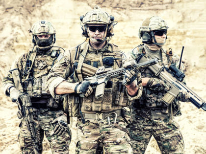 Group portrait of US army elite members, private military company servicemen, anti terrorist squad fighters standing together with guns. Brothers in arms, war conflict combatants, soldiers of fortune