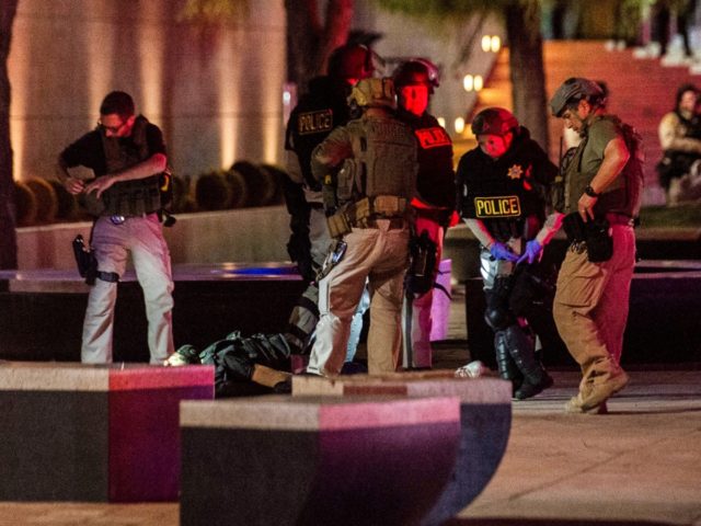 Police officers surround a person that was shot near the 300 block of South Las Vegas Boulevard, on June 1, 2020, in downtown Las Vegas, at the end of a rally in response to the recent death of George Floyd, an unarmed black man who died while in police custody. …