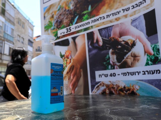 A bottle of sanitising gel stands at the entrance of restaurant in Jerusalem on May 27, 2020 as restaurants were allowed to open for the first time in months after the Israeli government approved the easing of measures put in place to stop the spread of the coronavirus Covid-19. (Photo …