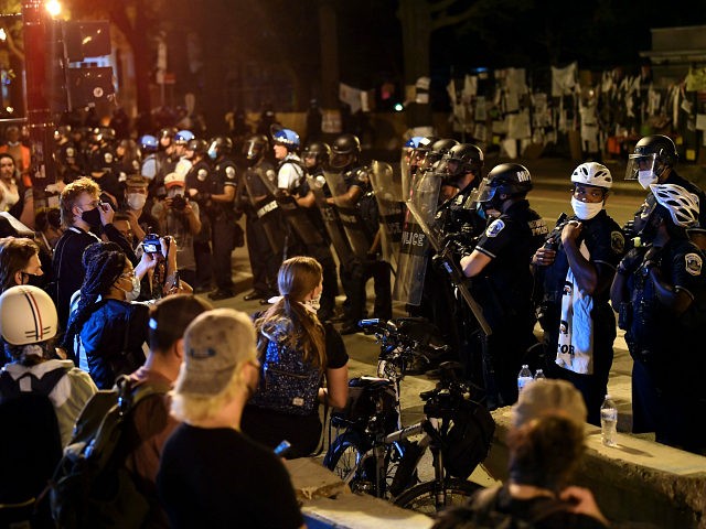 Protesters confront a row of police officers during demonstrations at Lafayette square, in