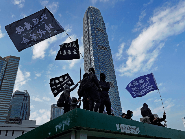 Protesters wave flags that read "Hong Kong Independence" during a rally in Hong Kong, Sund