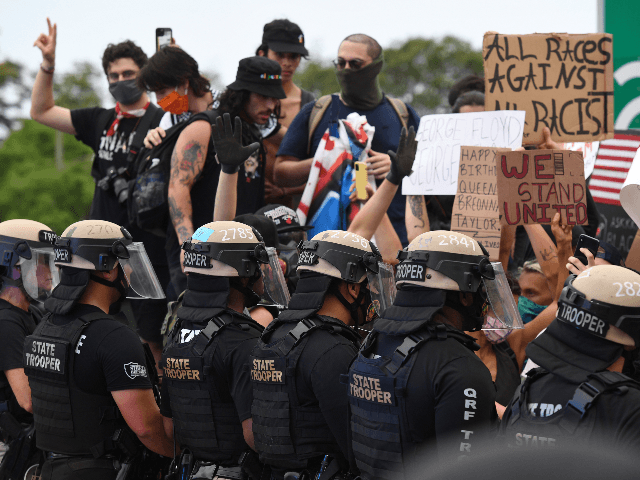 Protestors are seen engaging with Miami Police as the block access to Interstate 195 durin