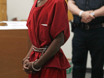 Dawit Kelete wears handcuffs chained to his waist as he walks into a court appearance Mond