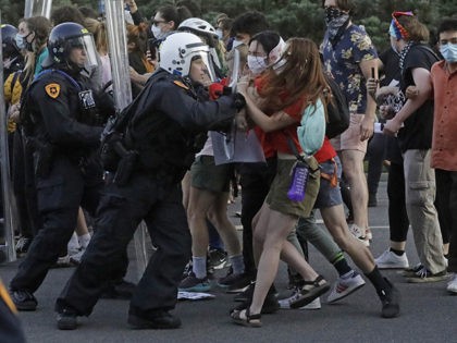 Protesters with police officers near the district attorney's office Thursday, July 9, 2020, in Salt Lake City. Two police officers in Utah were cleared earlier Thursday in the death of Bernardo Palacios-Carbajal, an armed man shot at more than 30 times as he ran from police, a decision that prompted …