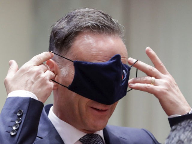 German Foreign Minister Heiko Maas puts on a face mask, to prevent the spread of coronavirus, as he attends an EU foreign ministers at the European Council building in Brussels, Monday, July 13, 2020. European Union foreign ministers meet for the first time face-to-face since the pandemic lockdown and will …