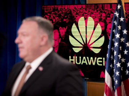 A monitor displays the logo for "Huawei" behind Secretary of State Mike Pompeo as he speaks during a news conference at the State Department in Washington, Wednesday, July 15, 2020. (AP Photo/Andrew Harnik, Pool)