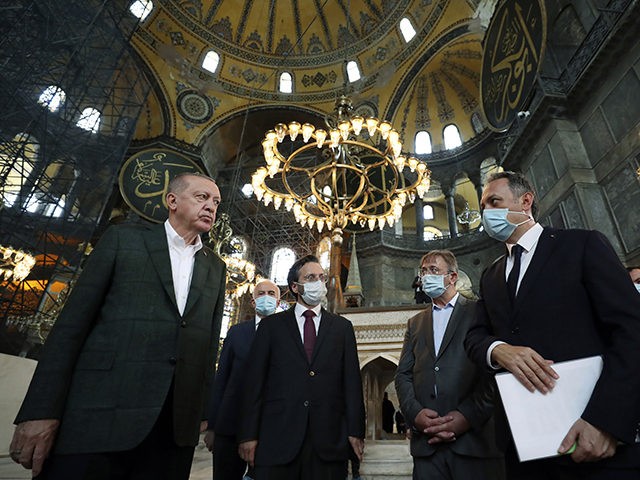 Turkey's President Recep Tayyip Erdogan, left, listens to an official as he visits the Byzantine-era Hagia Sophia, one of Istanbul's main tourist attractions in the historic Sultanahmet district of Istanbul, Sunday, July 19, 2020, days after he formally reconverted Hagia Sophia into a mosque and declared it open for Muslim …