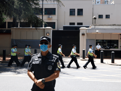 Chinese policemen march past the former United States Consulate in Chengdu in southwest China's Sichuan province on Monday, July 27, 2020. Chinese authorities took control of the former U.S. consulate in the southwestern Chinese city on Monday after it was ordered closed amid rising tensions between the global powers. (AP …