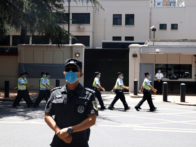 Chinese policemen march past the former United States Consulate in Chengdu in southwest Ch