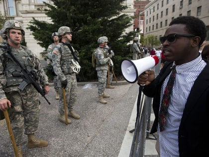 A protester talks with National Guard soldiers during a protest through Baltimore, Maryland on April 29, 2015, demanding justice for an African-American man who died of severe spinal injuries sustained in police custody. His death was the latest instance in the United States of a black man succumbing at the …