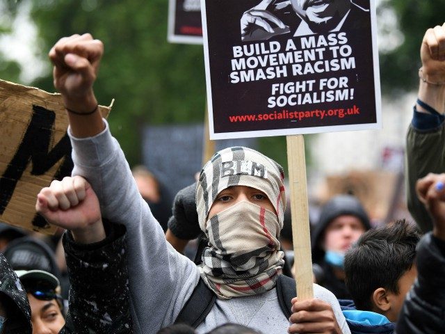 Activists, some wearing face coverings or face masks as a precautionary measure against COVID-19, attend a Black Lives Matter protest march from Hyde Park towards Parliament Square in London on June 12, 2020. - Britain has seen days of protests sparked by the death in police custody of George Floyd, …