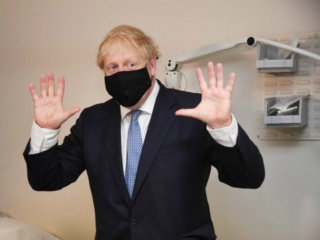 LONDON, ENGLAND - JULY 24: Prime minister Boris Johnson wears a face mask as he visits Tol