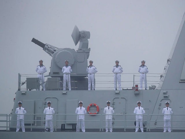 Sailors stand on the deck of the new type 055 guide missile destroyer Nanchang of the Chinese People's Liberation Army (PLA) Navy as it participates in a naval parade to commemorate the 70th anniversary of the founding of China's PLA Navy in the sea near Qingdao, in eastern China's Shandong …