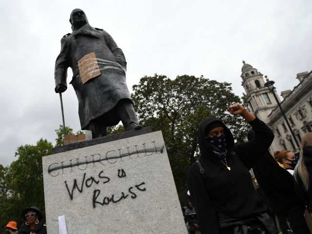 LONDON, UNITED KINGDOM - JUNE 07: Protesters gather in Parliament Square Garden around the statue of Winston Churchill which has graffiti with the words "was a racist" outside the Houses of Parliament in Westminster during a Black Lives Matter protest on June 07, 2020 in London, United Kingdom. The death …