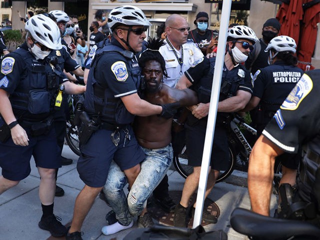 WASHINGTON, DC - JULY 04: Members of the DC Metropolitan Police arrest a black man at Black Lives Matter Plaza July 4, 2020 in Washington, DC. It’s uncertain why the man was arrested and brought away in a police van. (Photo by Alex Wong/Getty Images)