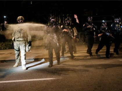 Federal officers use tear gas and other crowd dispersal munitions on protesters outside th