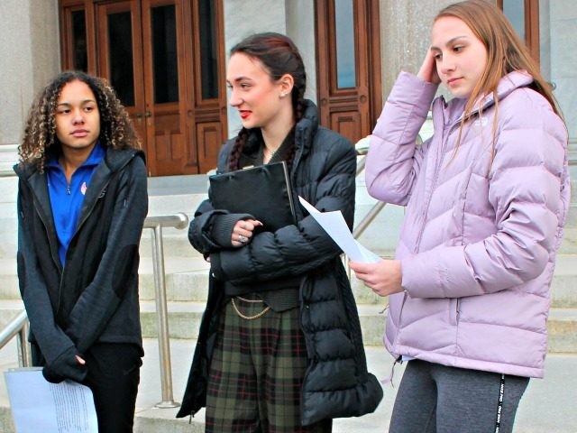 High school track athletes Alanna Smith, left, Selina Soule, center and and Chelsea Mitchell prepare to speak at a news conference outside the Connecticut State Capitol in Hartford, Conn. Wednesday, Feb. 12, 2020. The three girls have filed a federal lawsuit to block a state policy that allows transgender athletes …