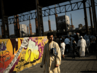 A man holding his praying carpet attends a Muslim morning prayer gathering at the industrial wasteland of Parco Dora in Turin on August 21, 2018, on the first day the Eid al-Adha, or Feast of Sacrifice, a four-day holiday which marks the end of the hajj. - The traditional four-day …