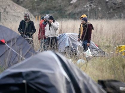 CALAIS, FRANCE - JANUARY 08: Migrants move their belongings as French police clear a migrant camp near Calais Port on January 08, 2019 in Calais, France. In recent weeks there has been an increase in migrants, many claiming to be from Iran, making the sea crossing from France to the …