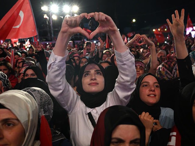 Supporters cheer as Turkish president speaks during a third anniversary commemoration rally at the Ataturk International Airport in Istanbul on July 15, 2019. - Turkey commemorates, on July 15, 2019 the third anniversary of a coup attempt which was followed by a series of purges in the public sector and …