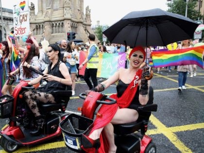 Members of the Lesbian, Gay, Bisexual and Transgender (LGBT) community and supporters take part in the Belfast Pride Parade 2019 in Belfast, Northern Ireland on August 3, 2019. - Northern Ireland's LGBT community take to the streets of Belfast in Pride celebrations buoyed by the promise that same-sex marriage rights …