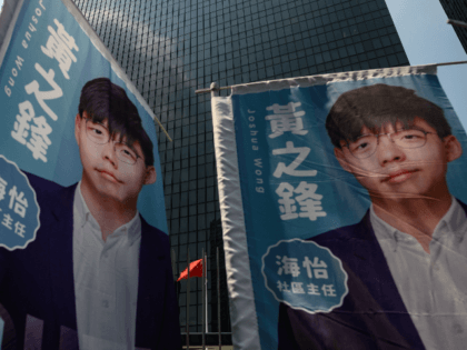 Banners of pro democracy activist and South Horizons Community Organiser Joshua Wong are placed in front of the Central Government Complex during the announcement of his run for 2019 District Council elections in Hong Kong on September 28, 2019 (Photo by Philip FONG / AFP) (Photo credit should read PHILIP …