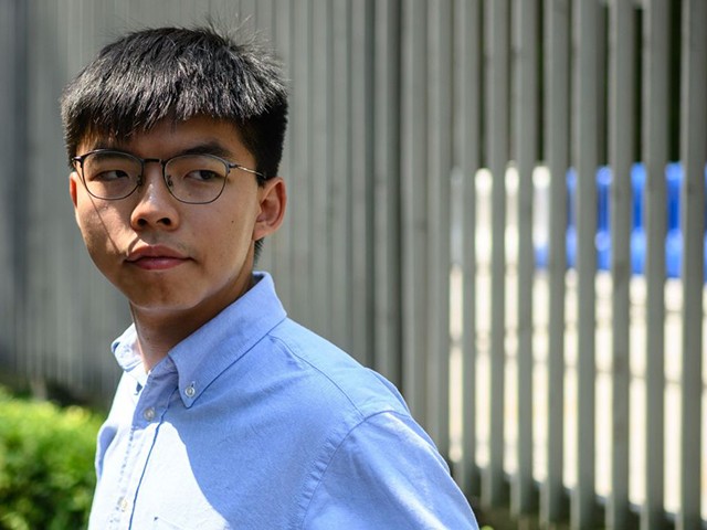 Pro democracy activist and South Horizons Community Organiser Joshua Wong stands in front of the Central Government Complex before the announcement of his run for 2019 District Council elections in Hong Kong on September 28, 2019 (Photo by Philip FONG / AFP) (Photo credit should read PHILIP FONG/AFP via Getty Images)