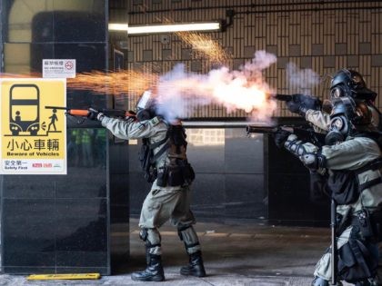 HONG KONG, CHINA - NOVEMBER 18: Riot police fire teargas and rubber bullets as protesters attempt to leave The Hong Kong Poytechnic University on November 18, 2019 in Hong Kong, China. Anti-government protesters armed with bricks, firebombs, and bows and arrows fought with the police at university campuses over the …