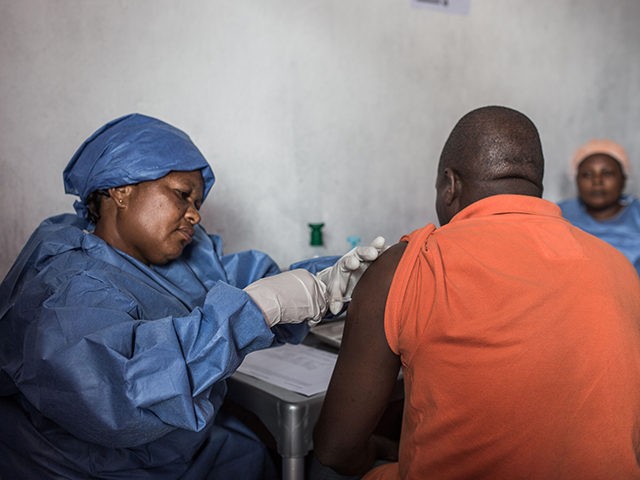 A man is getting inoculated with an Ebola vaccine on November 22, 2019 in Goma. (Photo by