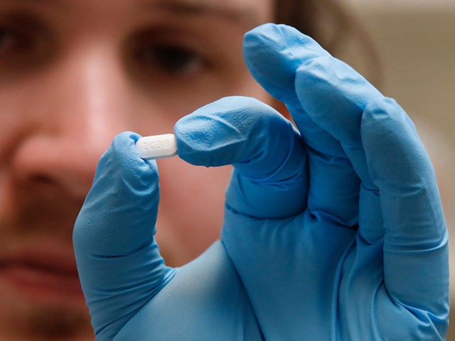 A pharmacy tech holds a pill of Hydroxychloroquine at Rock Canyon Pharmacy in Provo, Utah, on May 20, 2020. - US President Donald Trump announced May 18 he has been taking hydroxychloroquine for almost two weeks as a preventative measure against COVID-19. (Photo by GEORGE FREY / AFP) (Photo by …