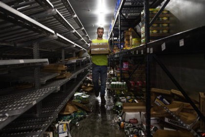 MINNEAPOLIS, MN - JUNE 05: A worker removes cases of beer from the cooler inside Chicago Lake Liquors after it was looted during the protests and riots which followed the death of George Floyd on June 5, 2020 in Minneapolis, Minnesota. All of the merchandise left in the store will …