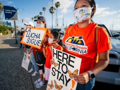 People hold signs during a rally in support of the Supreme Court's ruling in favor of the Deferred Action for Childhood Arrivals (DACA) program, in San Diego, California June 18, 2020. - Supreme Court dealt President Donald Trump's anti-immigration efforts a fresh blow Thursday when it rejected his cancellation of …