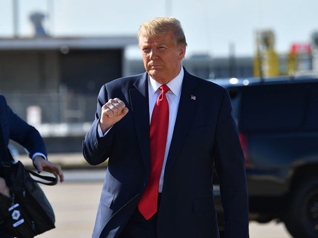 US President Donald Trump pumps his fist as he arrives at Tulsa International Airport on his way to his campaign rally at the BOK Center on June 20, 2020 in Tulsa, Oklahoma. - Hundreds of supporters lined up early for Donald Trump's first political rally in months, saying the risk …