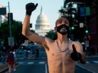 A Black Lives Matter protester wearing a "I Can't Breate" mask raises his fist during a demonstration near the US Capitol in Washington, DC on June 24, 2020. (Photo by ANDREW CABALLERO-REYNOLDS / AFP) (Photo by ANDREW CABALLERO-REYNOLDS/AFP via Getty Images)