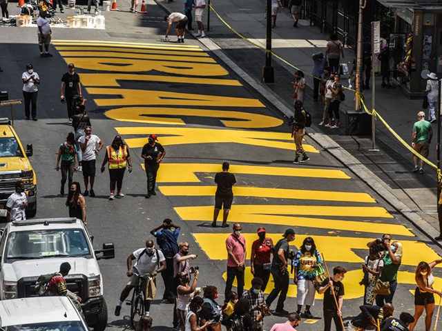 NEW YORK, NY - JUNE 26: Workers paint a Black Lives Matter mural on the street on June 26,