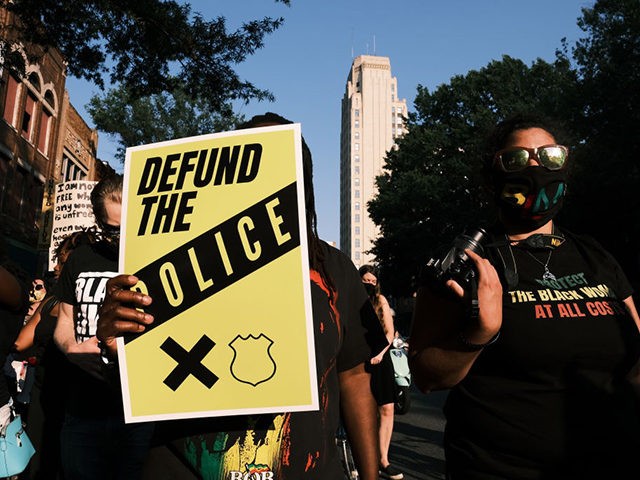 RICHMOND, VA - JULY 03: A protester carries a sign that reads "Defund The Police" during the Black Women Matter "Say Her Name" march on July 3, 2020 in Richmond, Virginia. Protests continue around the country after the death of African Americans while in police custody. (Photo by Eze Amos/Getty …