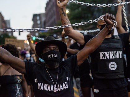 MINNEAPOLIS, MN - JULY 04: Demonstrators carry chains during the Black 4th protest in downtown on July 4, 2020 in Minneapolis, Minnesota. A number of protest demonstrations occurred around the Twin Cities on Independence Day which were critical of the annual American celebration. (Photo by Stephen Maturen/Getty Images)