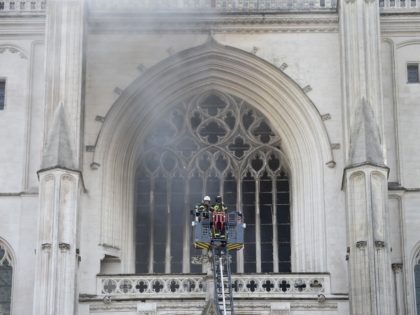 Firefighters are at work to put out a fire at the Saint-Pierre-et-Saint-Paul cathedral in Nantes, western France, on July 18, 2020. - A blaze that broke inside the gothic cathedral of Nantes on July 18 has been contained, emergency officials said, adding that the damage was not comparable to last …