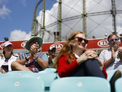 Spectators sit socially distanced leaving spaces between groups as a precaution against the spread of the novel coronavirus as they watch the friendly county cricket match between Surrey and Middlesex at the Oval in London on July 26, 2020. - The friendly cricket match between Surrey and Middlesex on July …