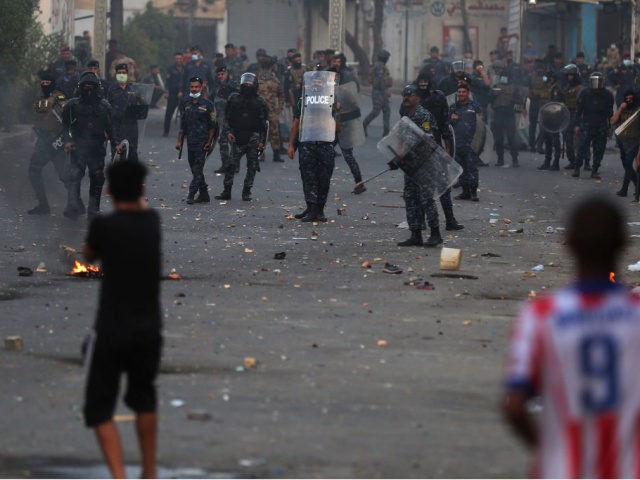 Iraqi demonstrators clash with security forces in al-Tayaran square in central Baghdad on