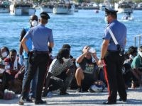 Migrants rescued by Italys' Guardia Costiera ( Coast Guard ) rests in the harbor of the Italian Pelagie Island of Lampedusa on July 29, 2020. - Boats with migrants mainly from Tunisia continue to arrive on the Italian island of Lampedusa. Intercepted by the boats of the Italian costal guard …