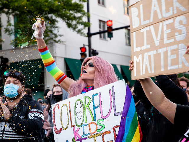 A drag queen throws glitter during a march in support of Black Lives Matter and Black Trans Lives in Boystown on June 14, 2020 in Chicago, Illinois. Protests erupted across the nation after George Floyd died in police custody in Minneapolis, Minnesota on May 25th. (Photo by Natasha Moustache/Getty Images)