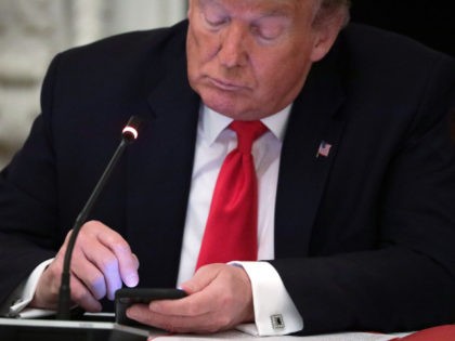 WASHINGTON, DC - JUNE 18: U.S. President Donald Trump works on his phone during a roundtable at the State Dining Room of the White House June 18, 2020 in Washington, DC. President Trump held a roundtable discussion with Governors and small business owners on the reopening of American’s small business. …