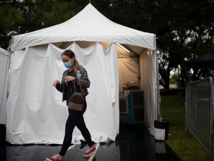 MIAMI LAKES, FLORIDA - JULY 22: Octavia Baldizon walks away from a medical tent where health care workers tested her for COVID-19 at a testing site locate at the Miami Lakes Youth Center on July 22, 2020 in Miami Lakes, Florida. Testing is being provided by doctors from New York …