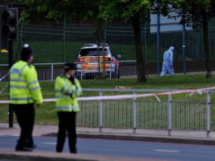 Police forensics officers search a cordoned off area in Woolwich, east London, on May 22,