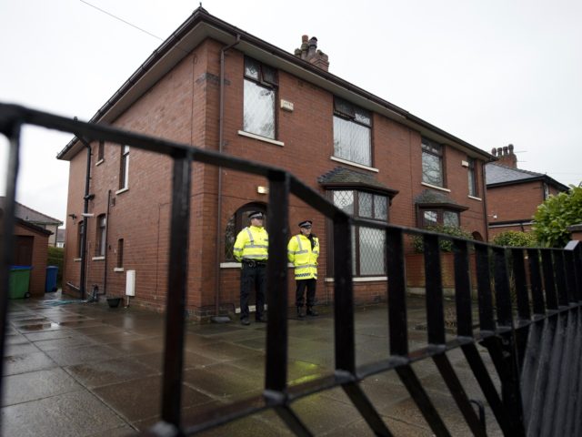Police officers stand guard outside the family home of one of nine British citizens currently detained by Turkish authorities for allegedly attempting to illegally enter Syria from Turkey, in Rochdale, northern England on April 3, 2015. The property is thought to be the home of British local councillor councillor Shakil …