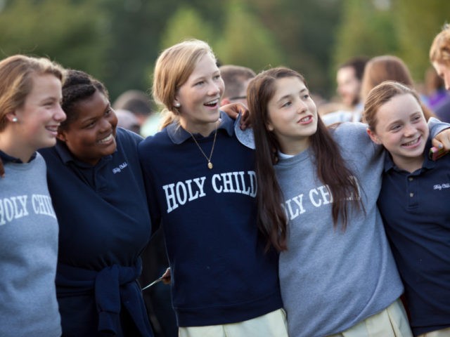 WASHINGTON, D.C. - SEPTEMBER 24: Middle and high school students of Holy Child School in Potomac, Maryland, gather for a group photo on the West Front of the U.S. Capitol building to watch a telecast of Pope Francis addressing a joint session of U.S. Congress on September 24, 2015 in …
